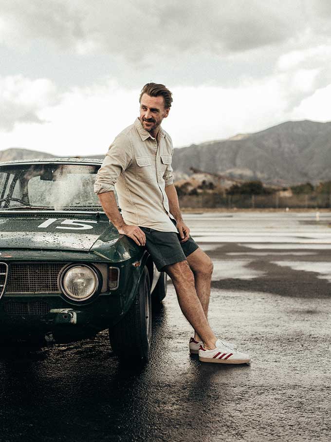 man leaning on car