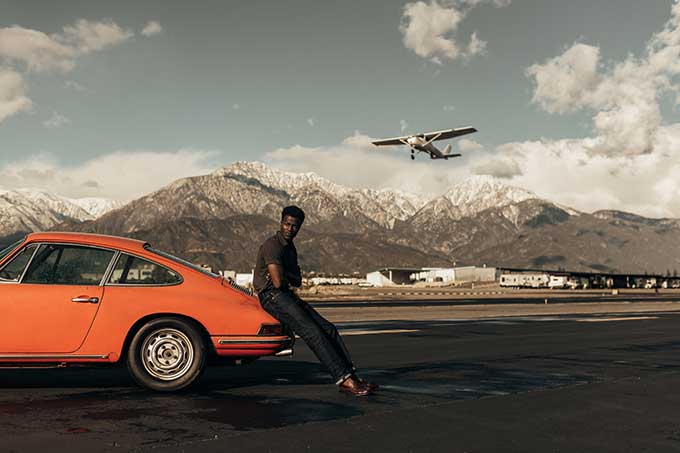 man leaning on car