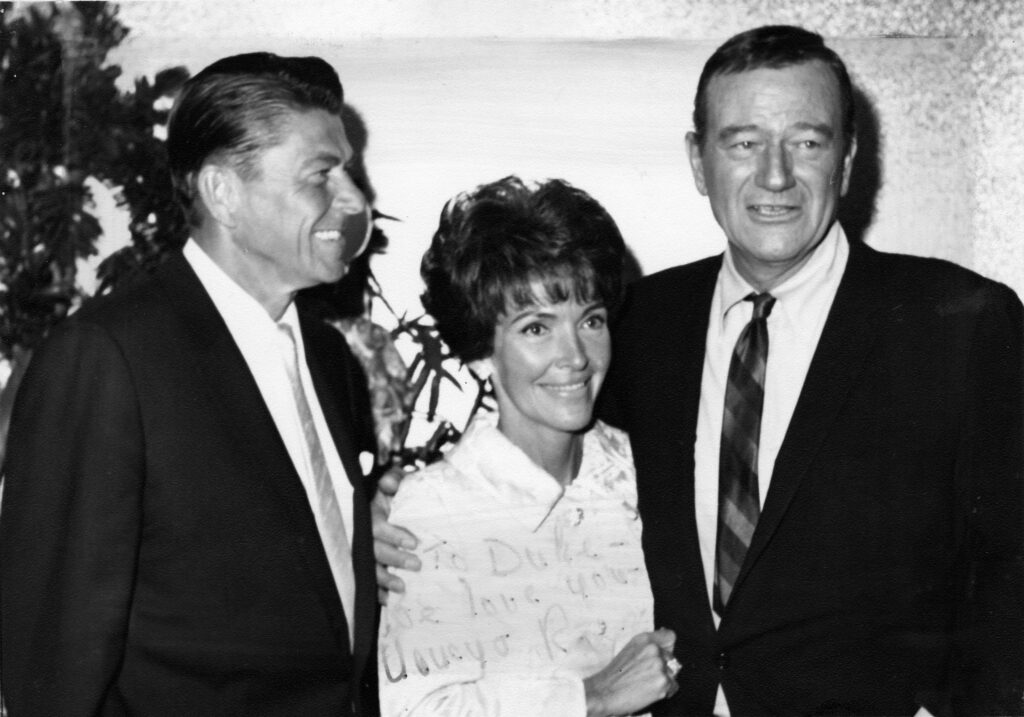 John Wayne with Ronald and Nancy Reagan, reflecting a lasting friendship.
