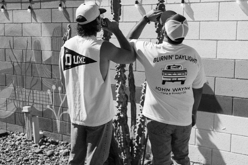 Stagecoach attendees wearing John Wayne Wild Goose T-shirts during a 90-degree weekend in Indio, California.