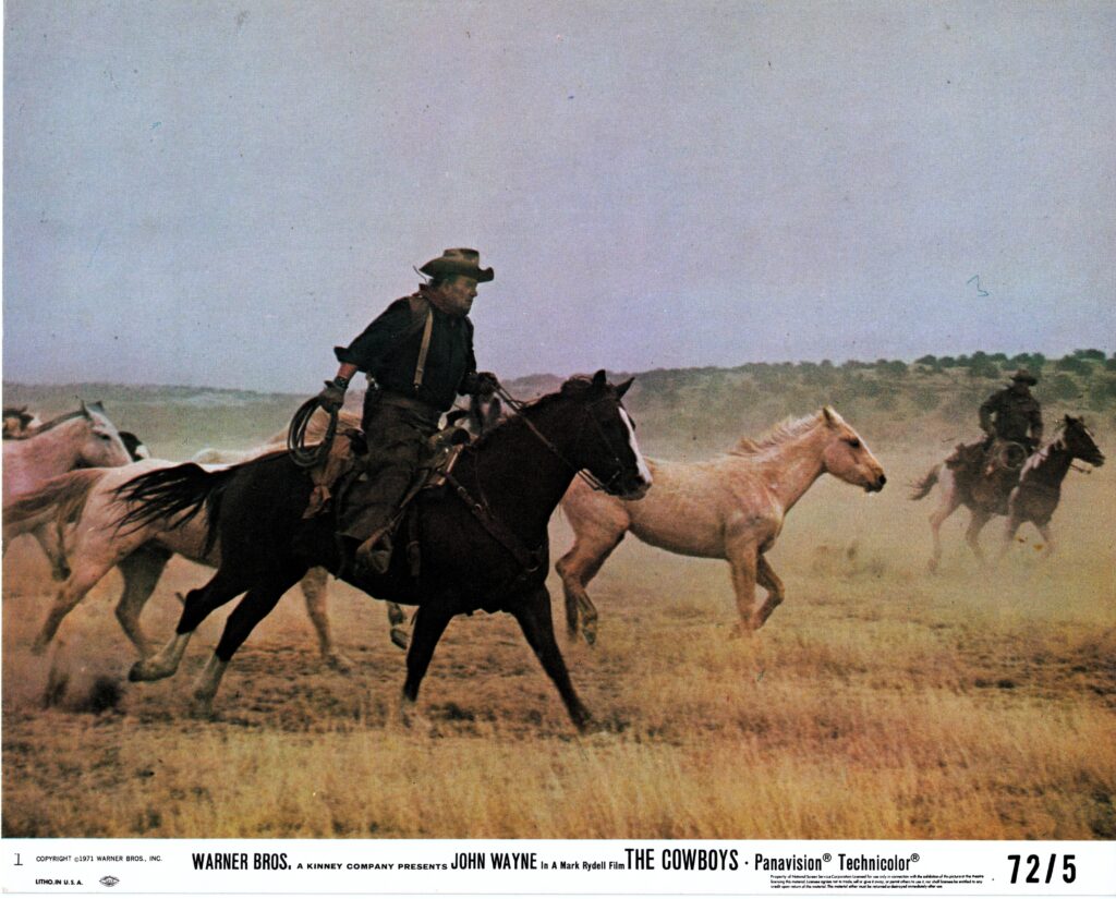 John Wayne and the young cowhands crossing the open New Mexico landscape in The Cowboys